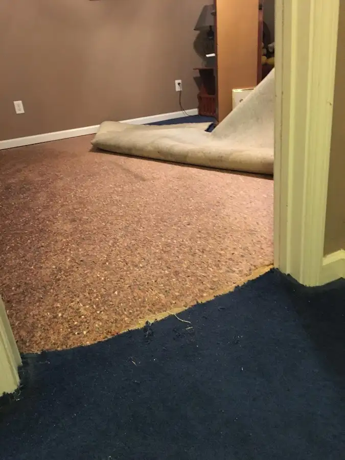 Carpet pad removal revealing water damage during Drying & Dehumidification in Keokuk