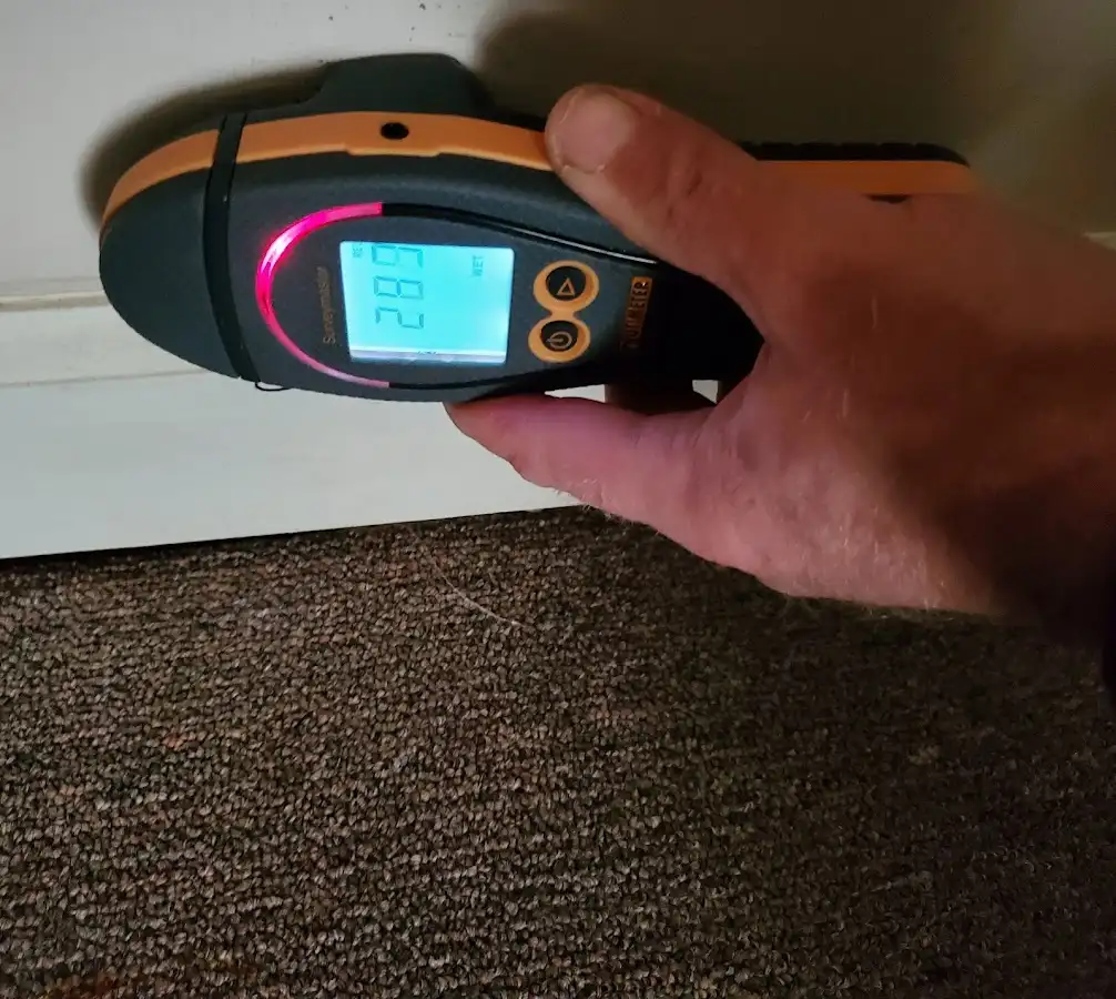 Moisture detection at baseboard during Storm Damage Restoration in Keokuk